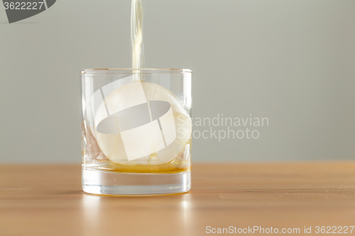 Image of Whiskey or brandy being poured into a glass