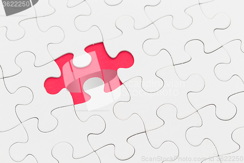 Image of Plain white jigsaw puzzle on Red background