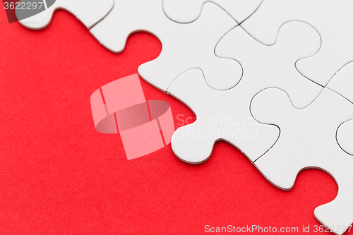 Image of Jigsaw puzzle on red paper