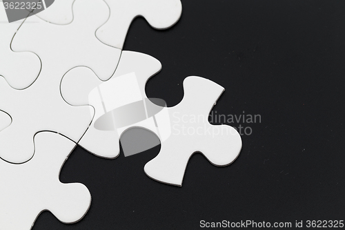 Image of Plain white jigsaw puzzle on Black background