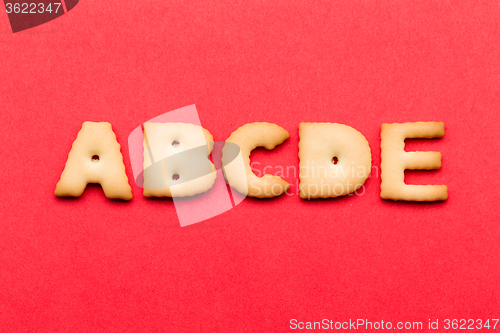 Image of ABCDE cookie over the red background