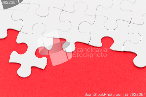 Image of Jigsaw puzzle over red background