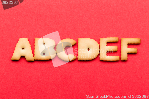 Image of ABCDE biscuit over the red background
