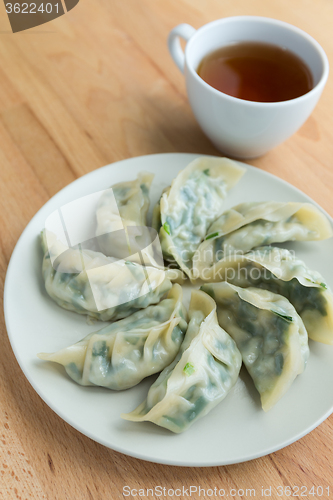 Image of Chinese meat dumpling with a cup of tea