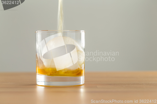 Image of Pouring whiskey in glass