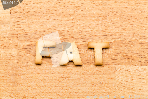 Image of Word fat cookie over the wooden background