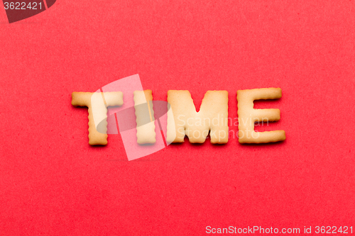 Image of Word time biscuit over the red background