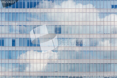 Image of Cloud reflected in windows of modern office building