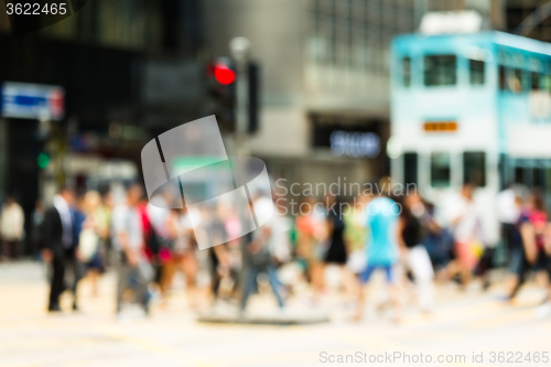 Image of Blurred view of the people crossing the road