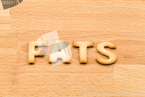 Image of Word fats biscuit over the wooden background