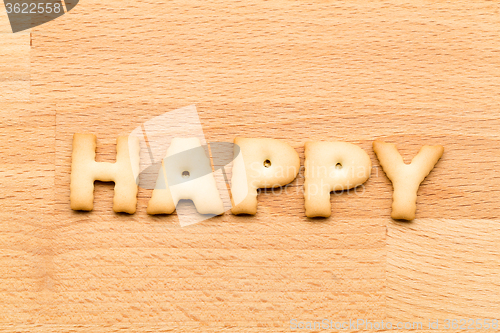 Image of Word happy cookie over the wooden background