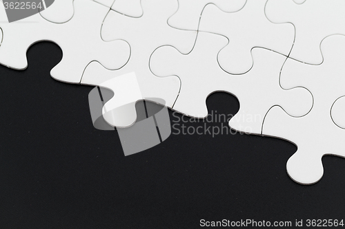 Image of White puzzle on a black background