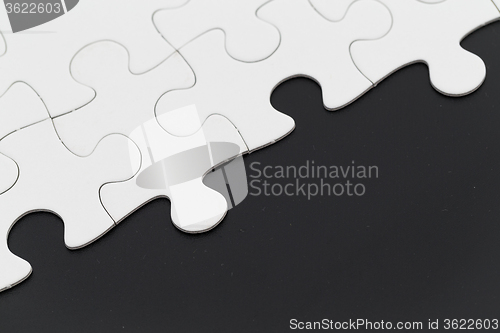 Image of White puzzle on black background