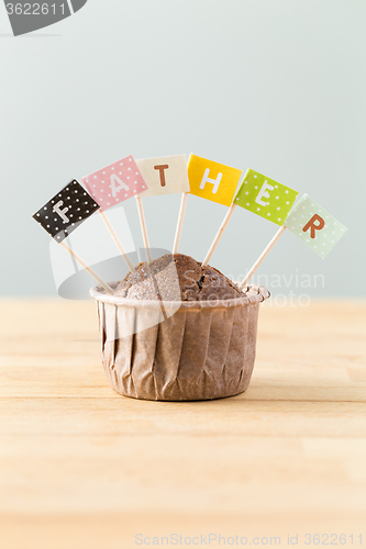Image of Chocolate muffins with small flag of a word father
