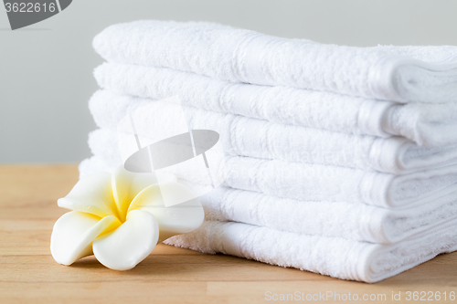 Image of Plumeria flower with stack of white towel