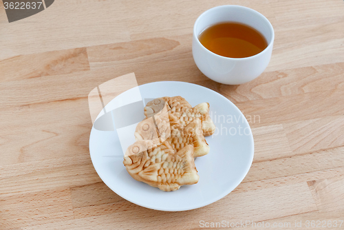 Image of Japanese confectionery taiyaki fish cake wagashi on plate with t