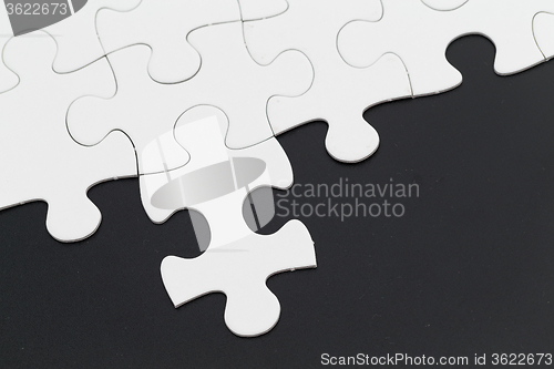 Image of Plain white jigsaw puzzle on Black background