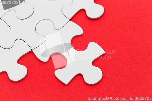 Image of Jigsaw puzzle with missing red background