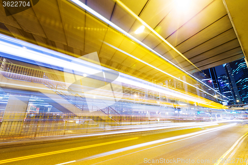 Image of Fast moving car at night in modern city