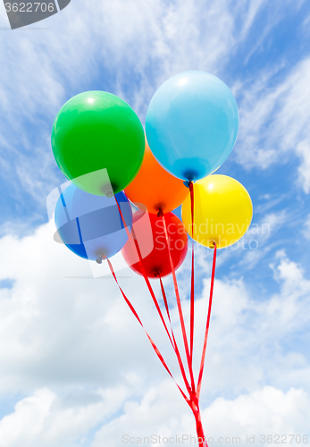 Image of Bunch of colorful balloons in blue sky