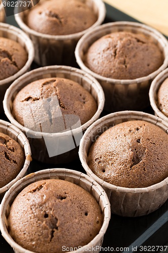 Image of Fresh muffins on wooden background