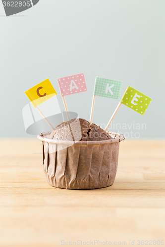 Image of Chocolate muffins with small flag of a word cake