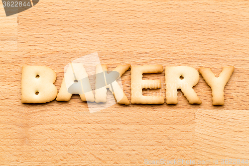 Image of Word bakery biscuit over the wooden background