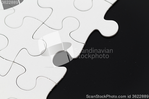 Image of White puzzle on a black background