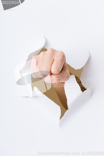 Image of Fist coming out the paper hole