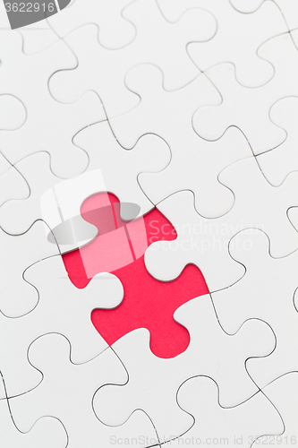 Image of Plain white jigsaw puzzle with missing piece