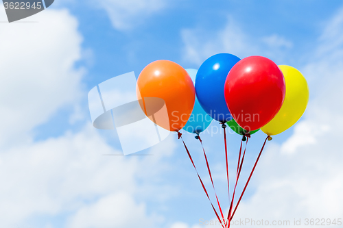 Image of Bunch of colorful balloons in blue sky