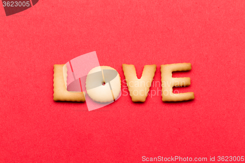 Image of Word LOVE biscuit over the red background