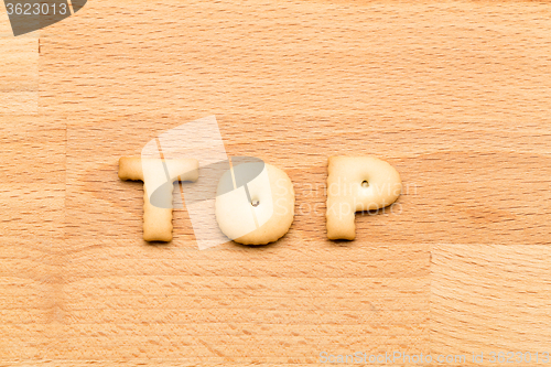 Image of Word top cookie over the wooden background