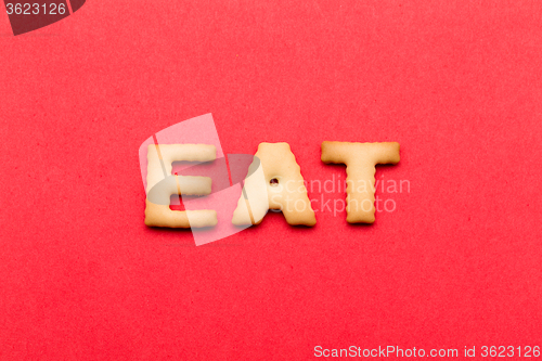 Image of Word eat cookie over the red background