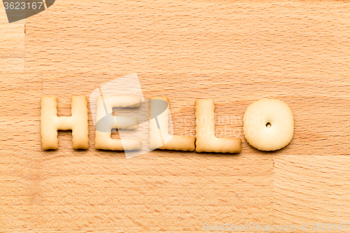 Image of Word hello cookie over the wooden background