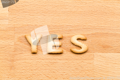 Image of Word yes cookie over the wooden background