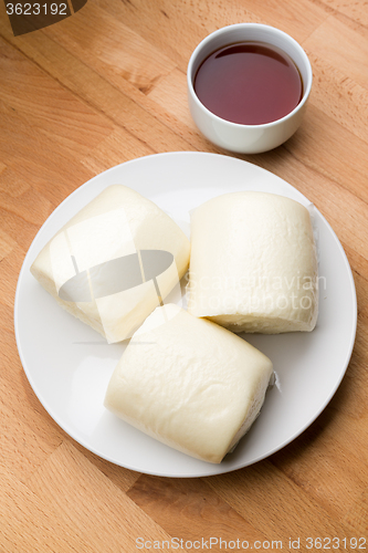 Image of Chinese steamed bun with a glass of tea