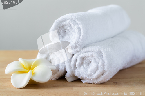 Image of Frangipani flower with towel won wooden table