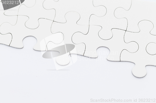 Image of White puzzle on blank paper