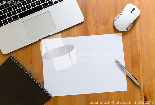 Image of Working desk with laptop computer blank paper for advertising