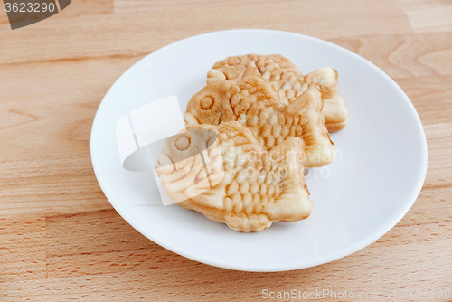 Image of Taiyaki of japanese traditional baked sweets on wooden table