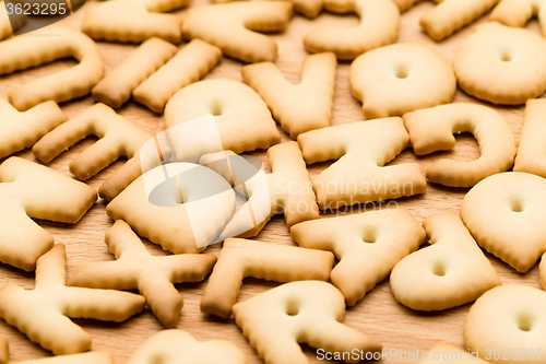 Image of Baked text biscuit over the wooden table