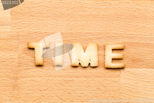 Image of Word time cookie over the wooden background