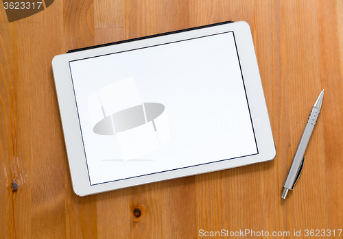 Image of Digital Tablet and pen on a desk and presenting a blank screen f