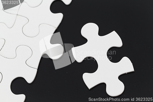 Image of White puzzle on black background