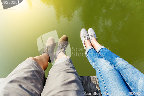 Image of Woman and man legs in water pond