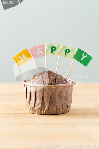 Image of Flag on muffin with a word happy