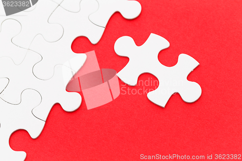 Image of Jigsaw puzzle on red background 