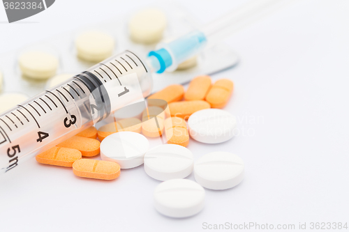 Image of Syringe and some pills