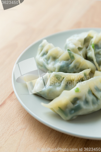 Image of Chinese meat dumpling on the white plate